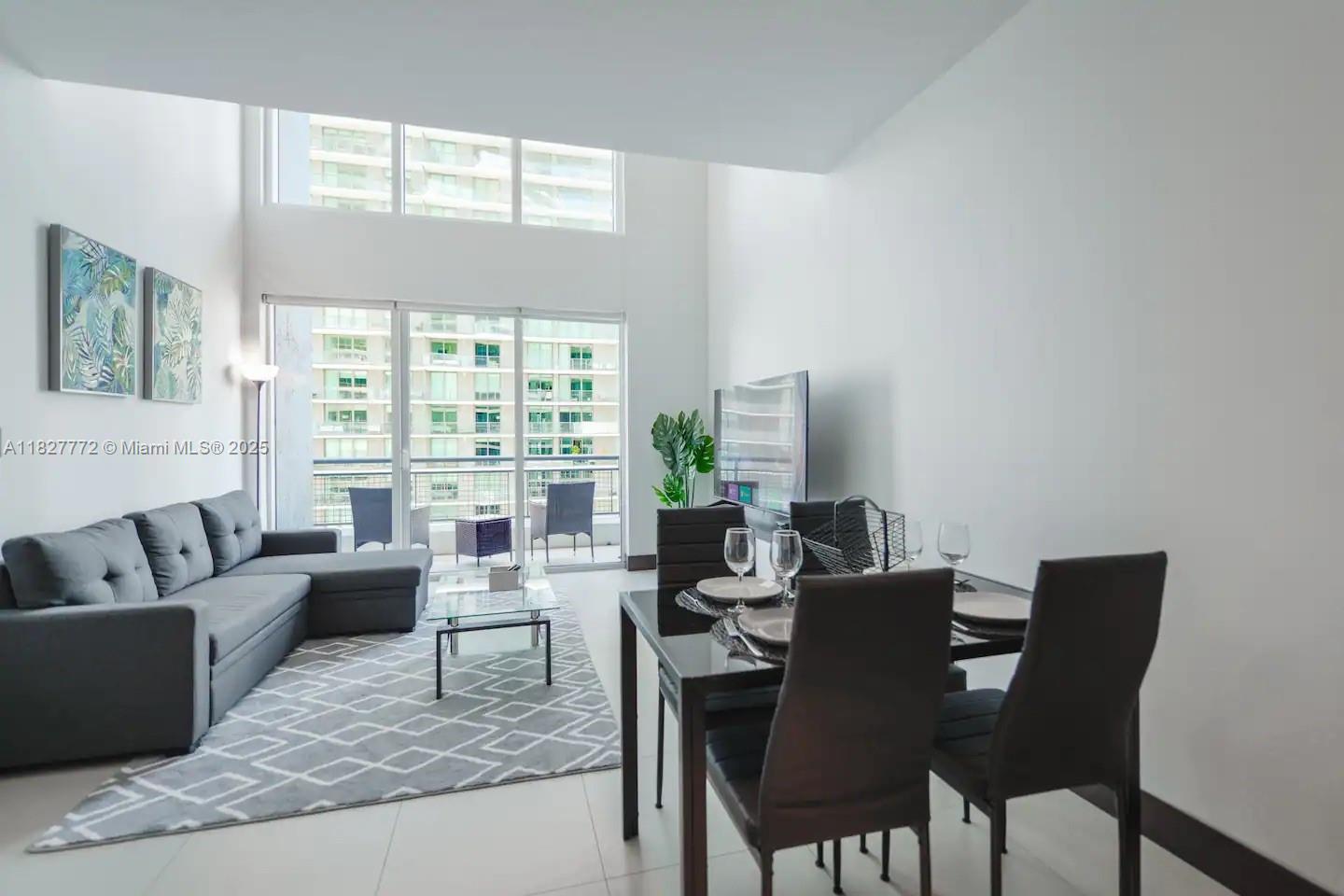 Brickell Miami, FL 33130 - Photo 3 of 26 a living room with furniture and a large window