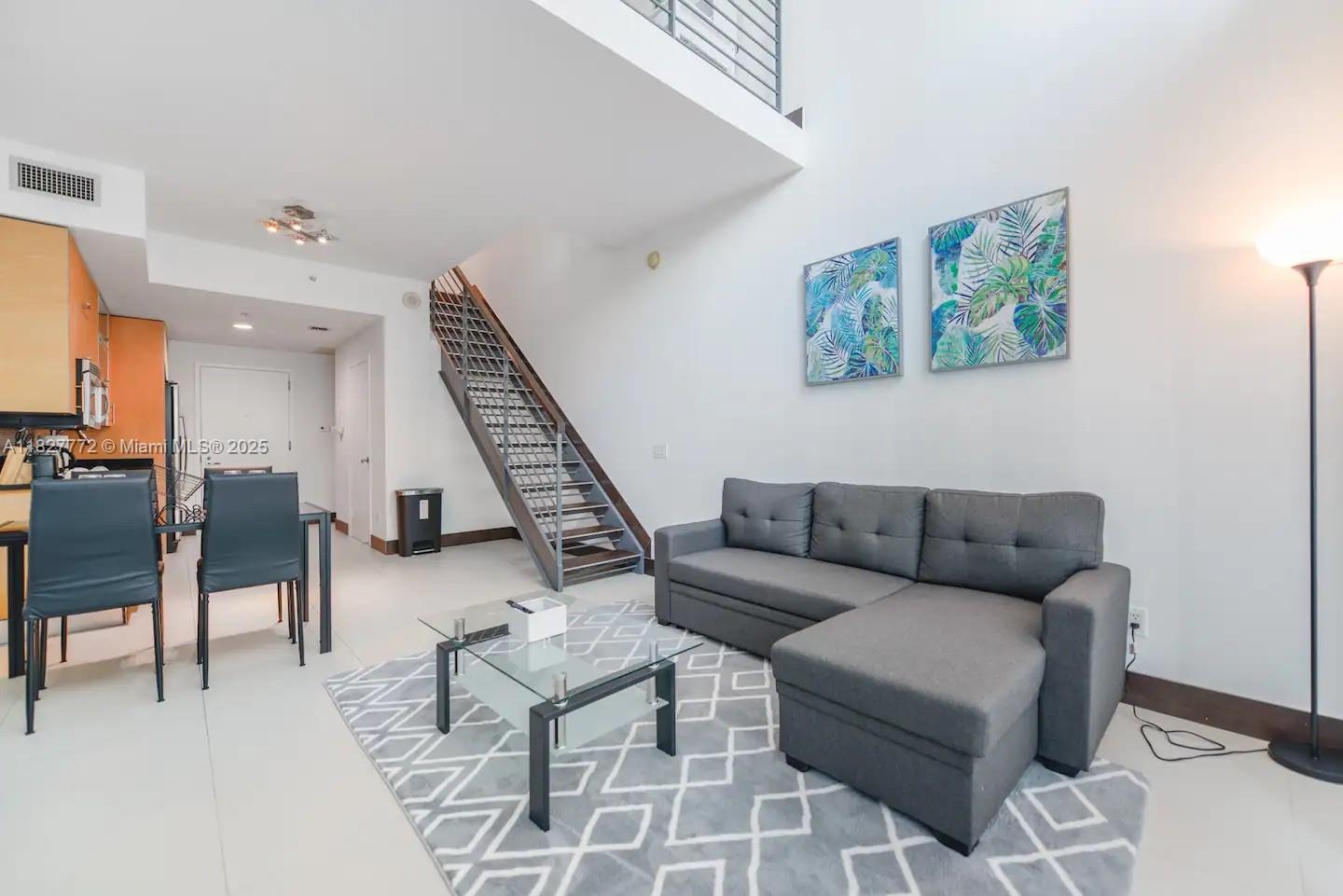 Brickell Miami, FL 33130 - Photo 4 of 26 a living room with furniture and a wooden floor