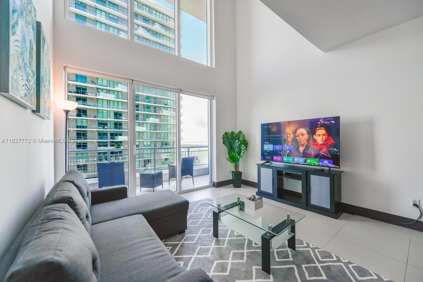 Brickell Miami, FL 33130 - Photo 5 of 26 a living room with furniture and a flat screen tv