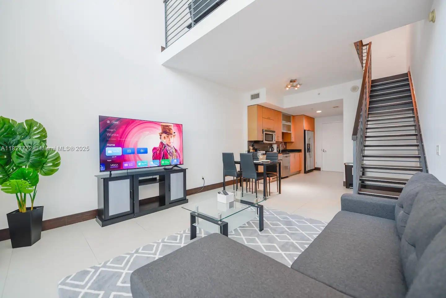 Brickell Miami, FL 33130 - Photo 6 of 26 a living room with furniture and a flat screen tv