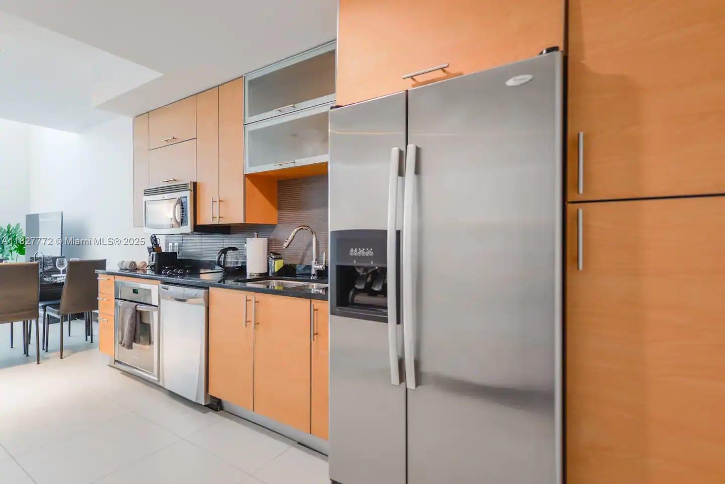 Brickell Miami, FL 33130 - Photo 9 of 26 a kitchen with stainless steel appliances granite countertop a refrigerator and a stove