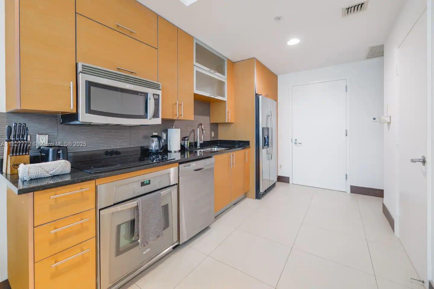 Brickell Miami, FL 33130 - Photo 10 of 26 a kitchen with stainless steel appliances granite countertop a refrigerator and a stove top oven