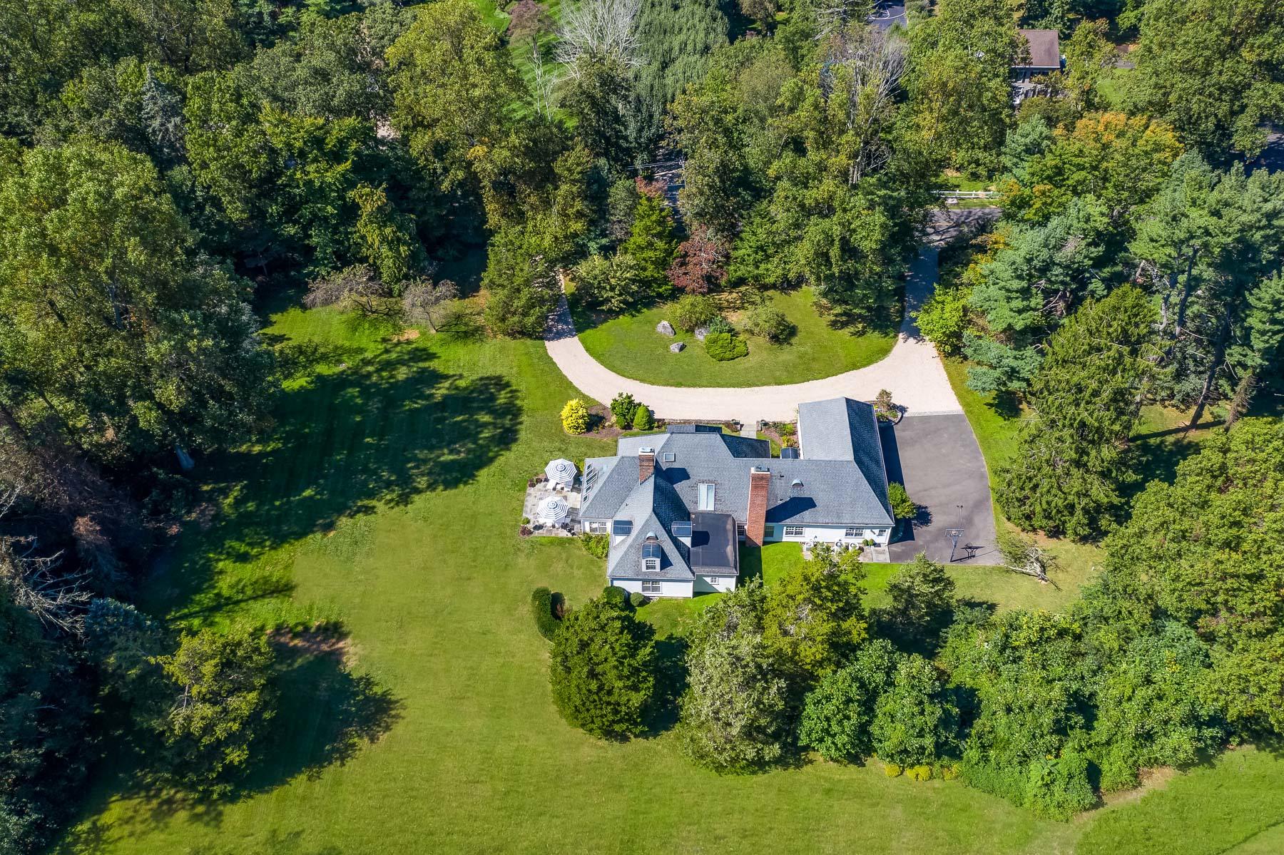 860 Hollow Tree Ridge Road Darien, CT 06820 - Photo 1 of 23 an aerial view of a house with yard swimming pool and outdoor seating
