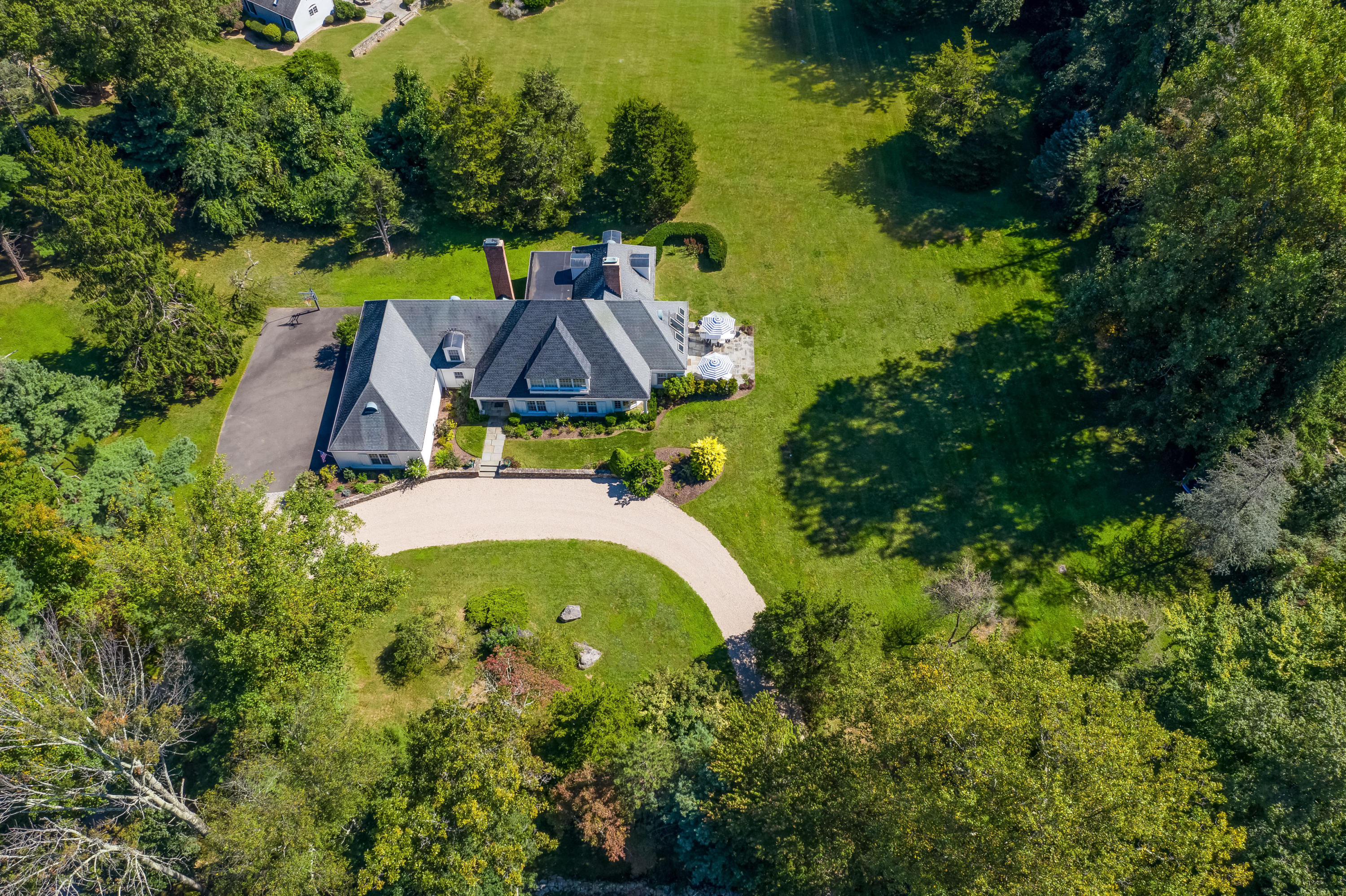 860 Hollow Tree Ridge Road Darien, CT 06820 - Photo 19 of 23 an aerial view of a house with swimming pool and garden