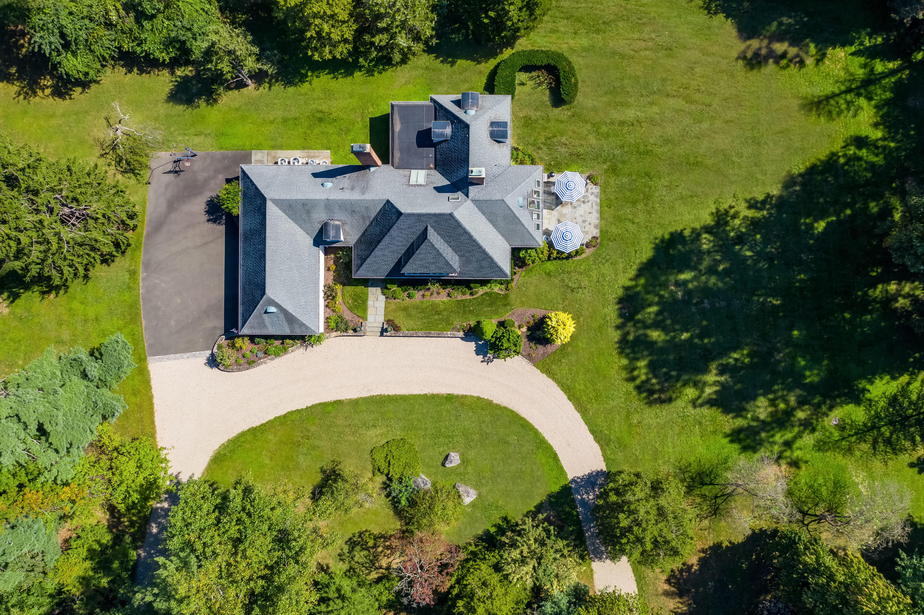 860 Hollow Tree Ridge Road Darien, CT 06820 - Photo 20 of 23 an aerial view of a house with swimming pool and garden