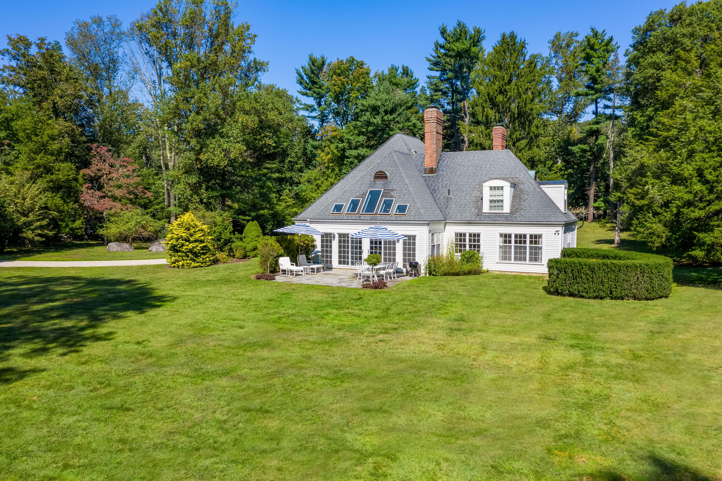 860 Hollow Tree Ridge Road Darien, CT 06820 - Photo 2 of 23 a front view of a house with a garden