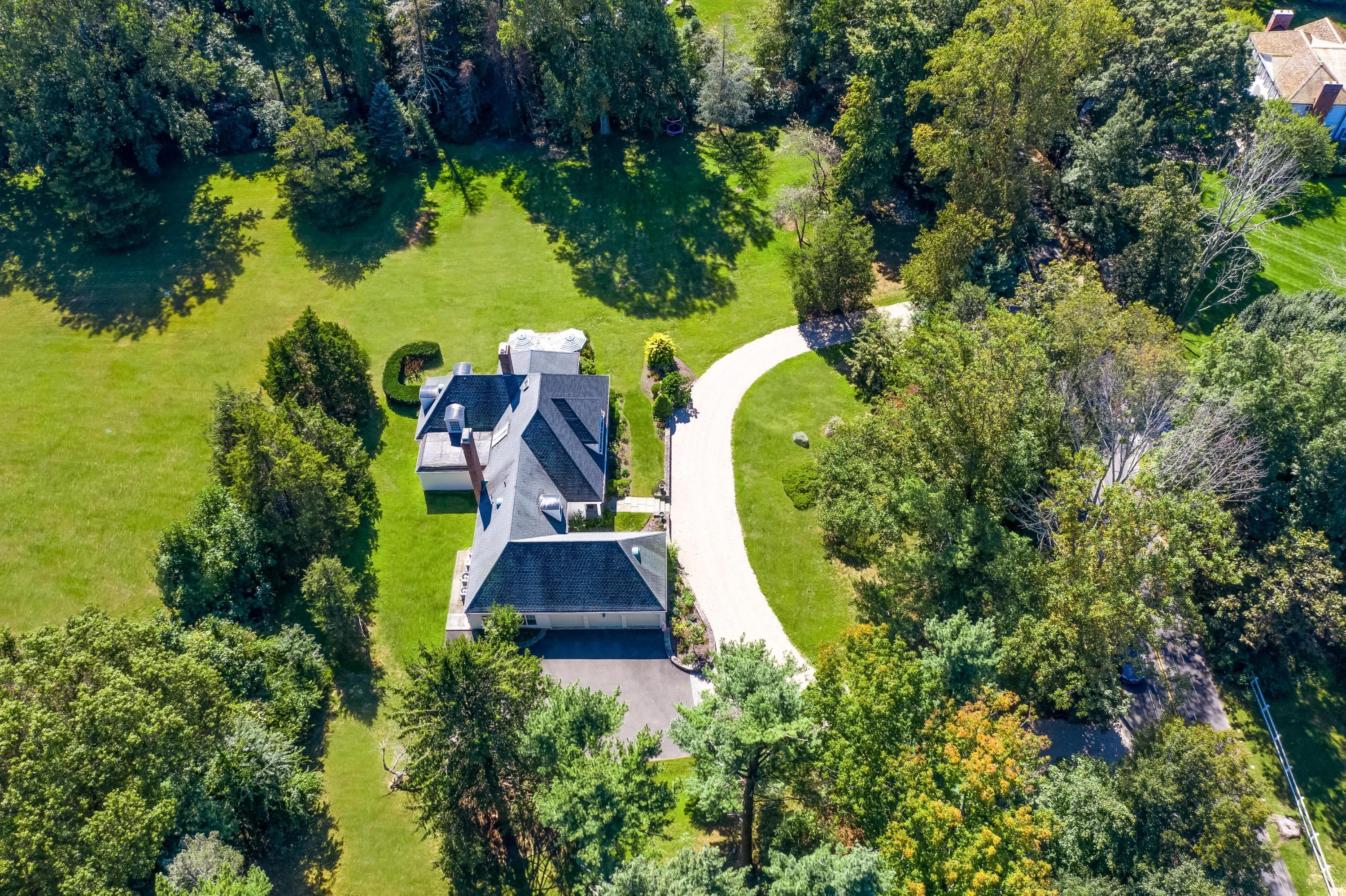 860 Hollow Tree Ridge Road Darien, CT 06820 - Photo 21 of 23 an aerial view of a house with swimming pool and large trees