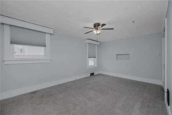 a view of an empty room with a fan