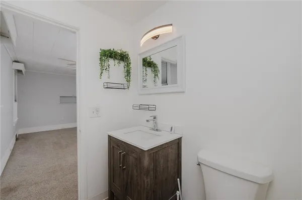 a bathroom with a sink a toilet and mirror
