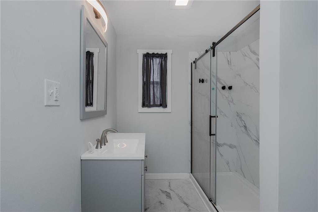 933 Oak Street Indiana, PA 15701 - Photo 21 of 28 a bathroom with a shower sink and mirror