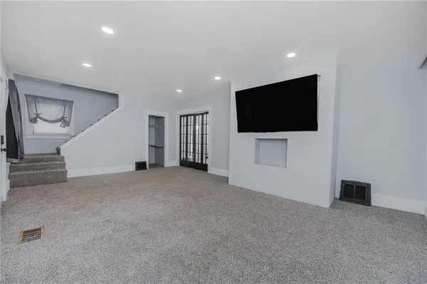 a view of an empty room with a flat screen tv