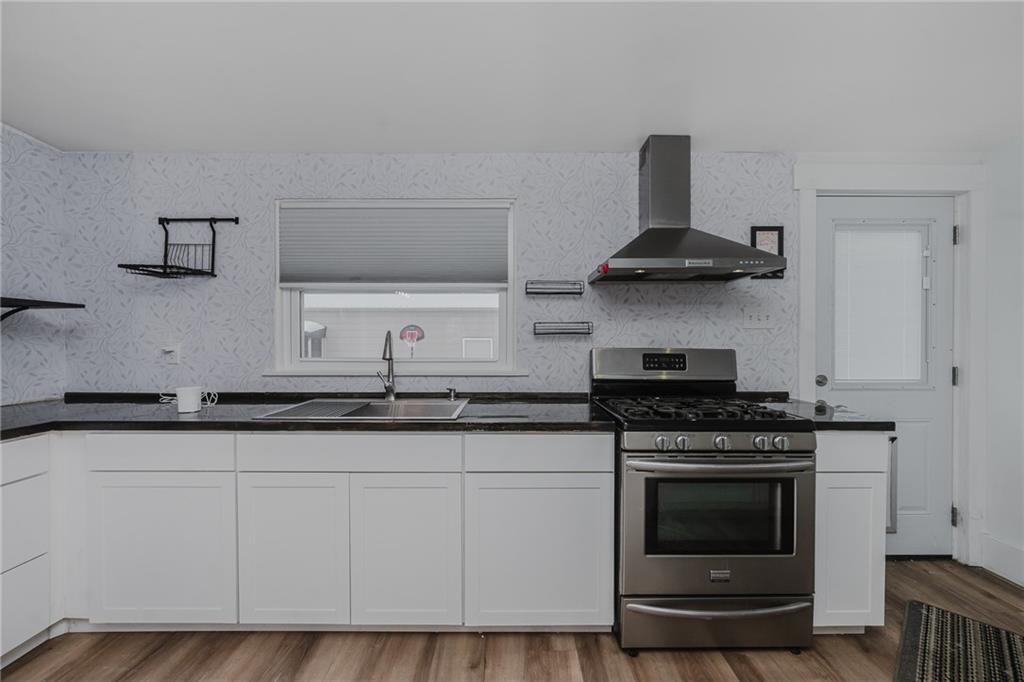 933 Oak Street Indiana, PA 15701 - Photo 6 of 28 a kitchen with granite countertop a stove and a sink