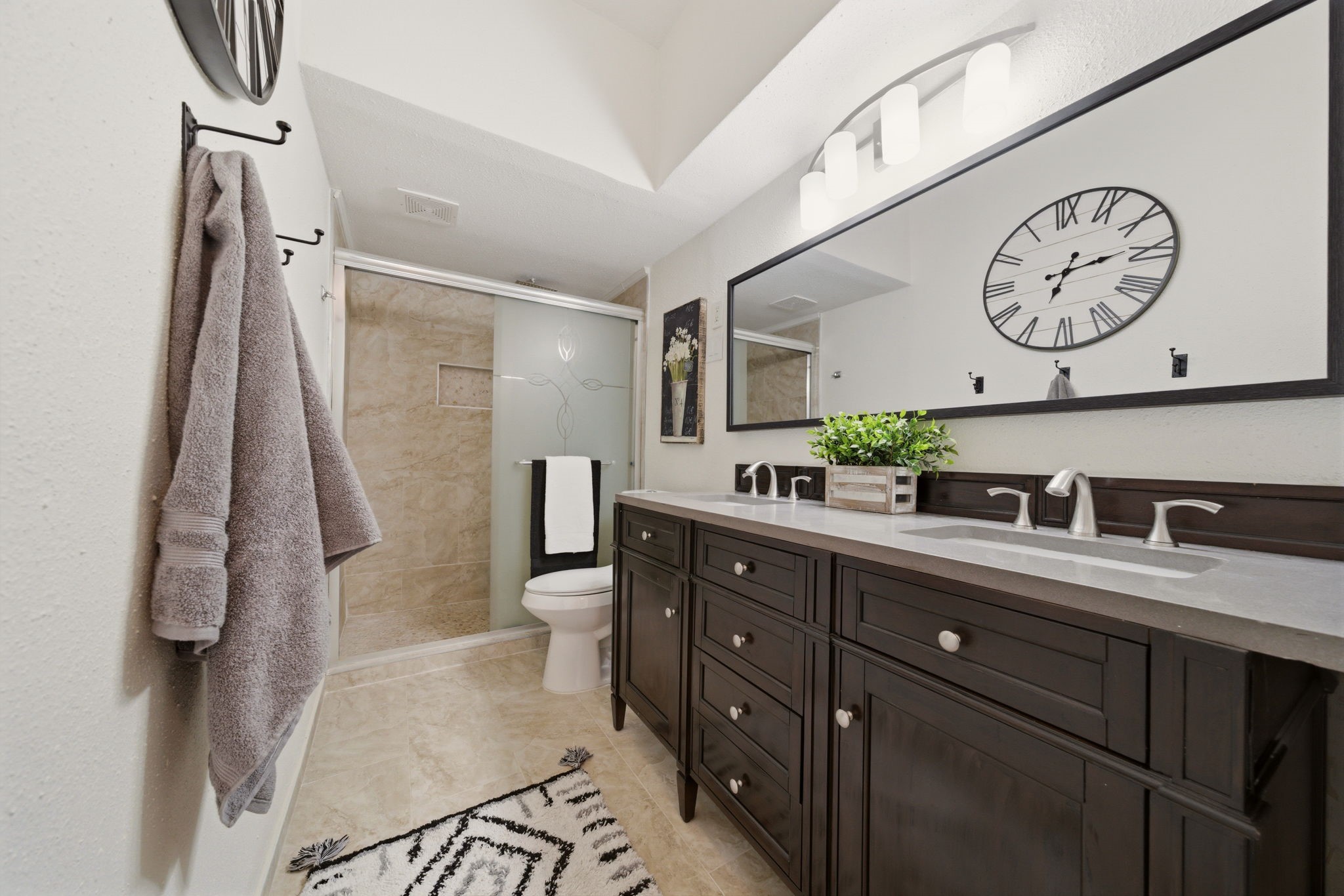 2100 Tanglewilde Street, Unit 750 Houston, TX 77063 - Photo 13 of 23 Large shower with a modern double vanity. Recently updated.