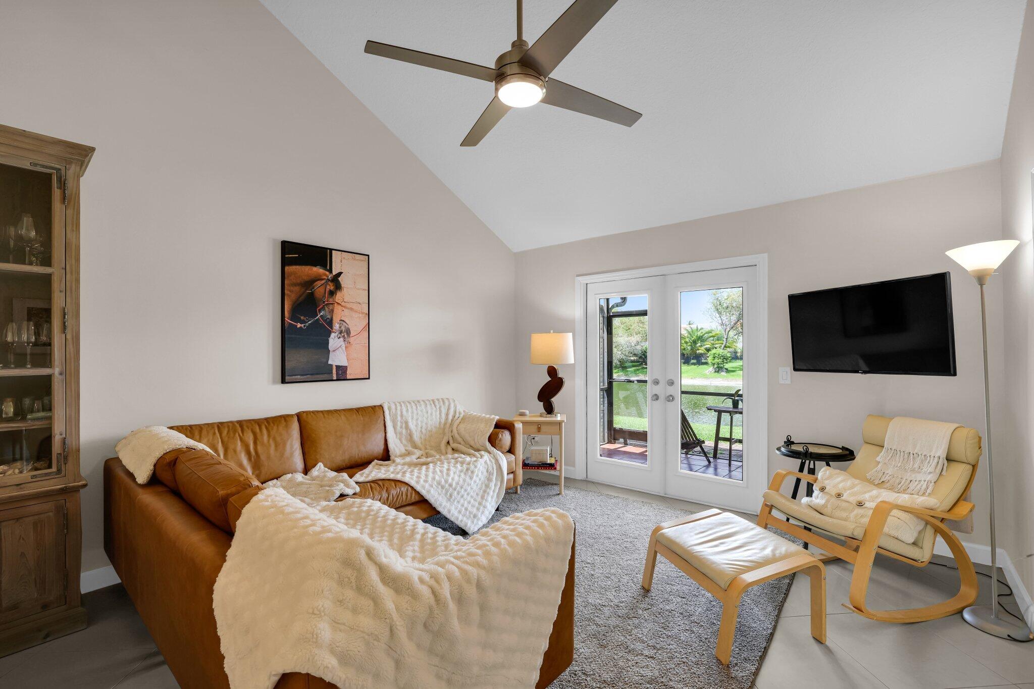 10323 Hidden Springs Court Boca Raton, FL 33498 - Photo 11 of 41 a living room with furniture and a flat screen tv