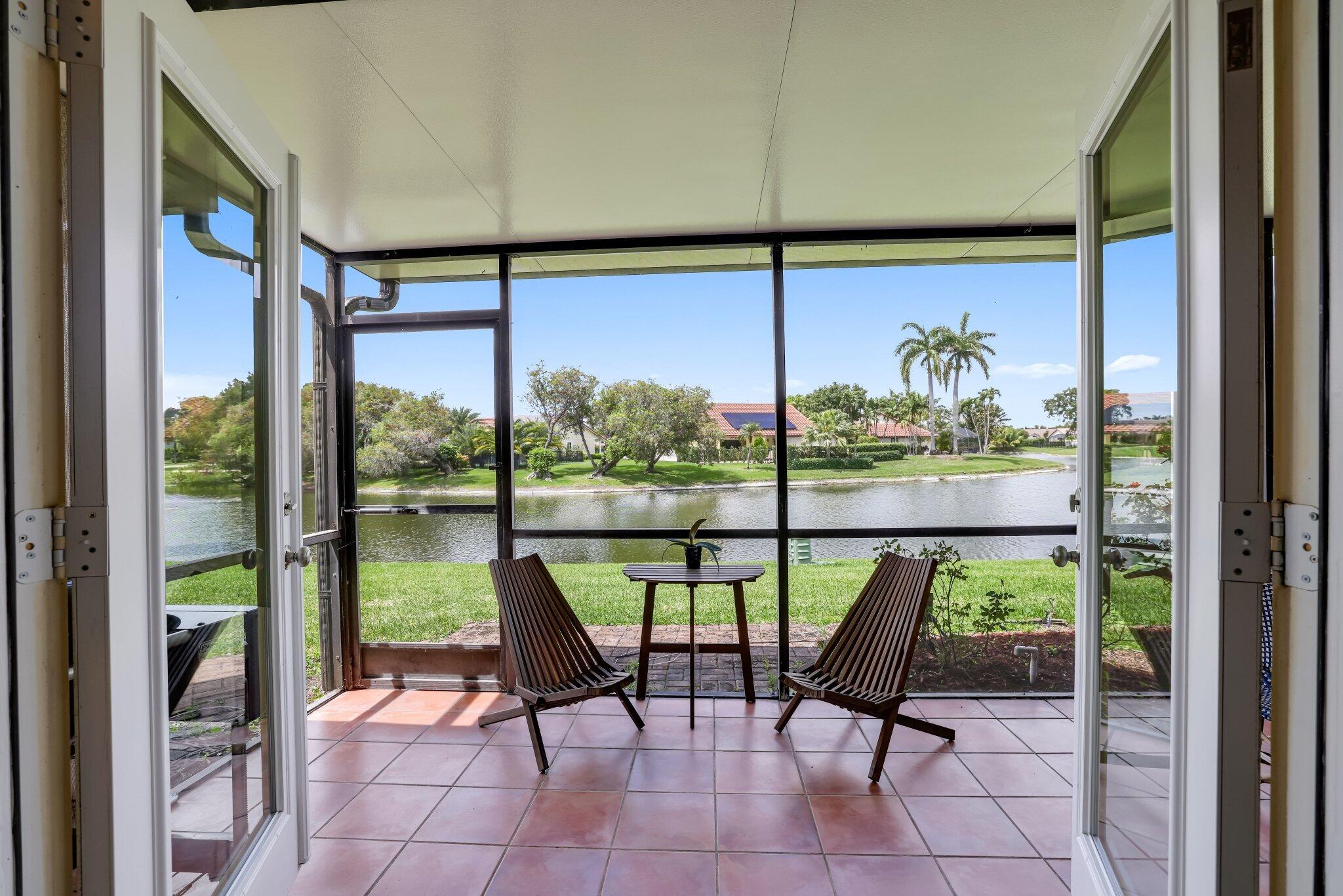 10323 Hidden Springs Court Boca Raton, FL 33498 - Photo 13 of 41 a view of a room with a furniture and floor to ceiling window