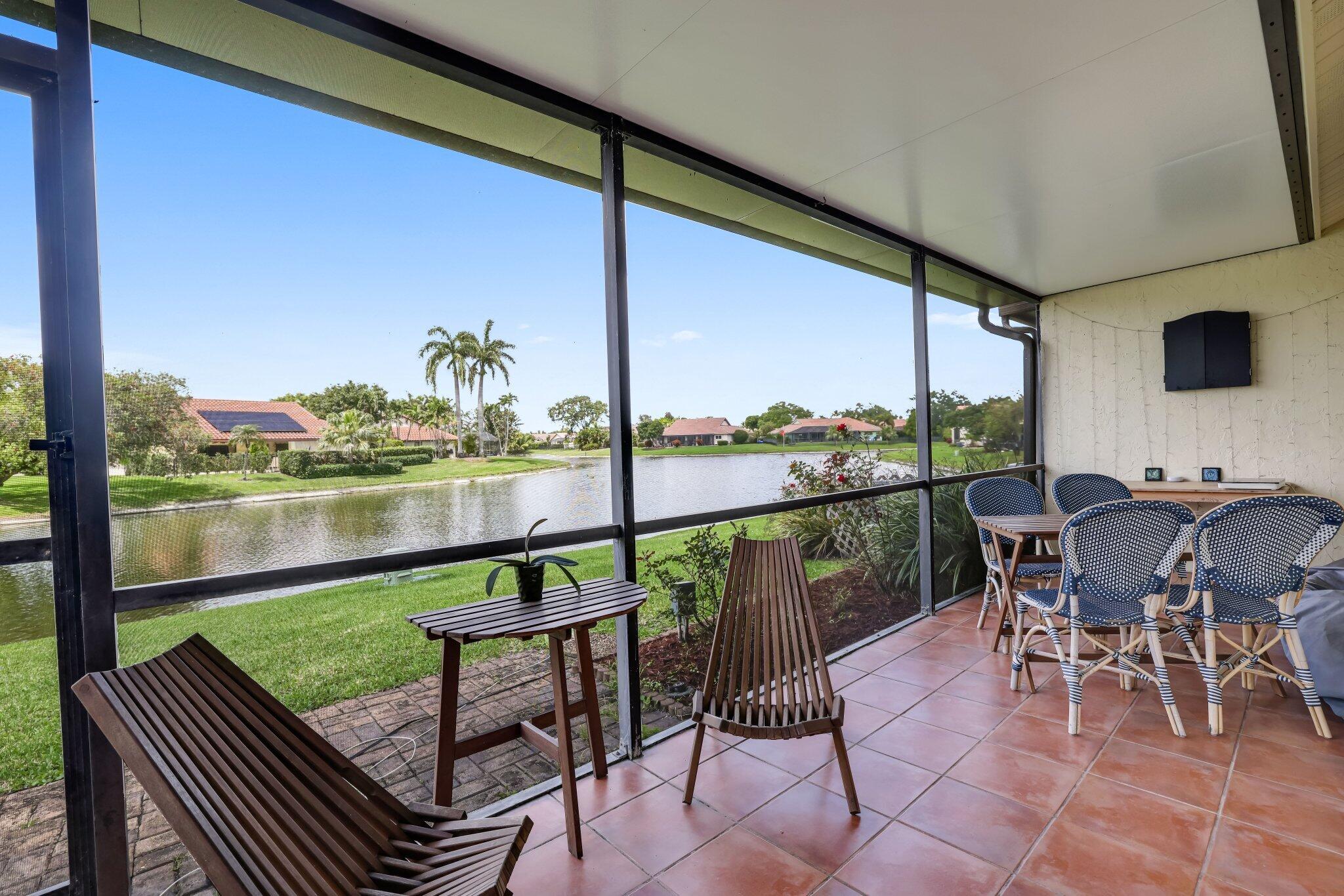 10323 Hidden Springs Court Boca Raton, FL 33498 - Photo 14 of 41 a view of a chairs and table in patio with a lake view