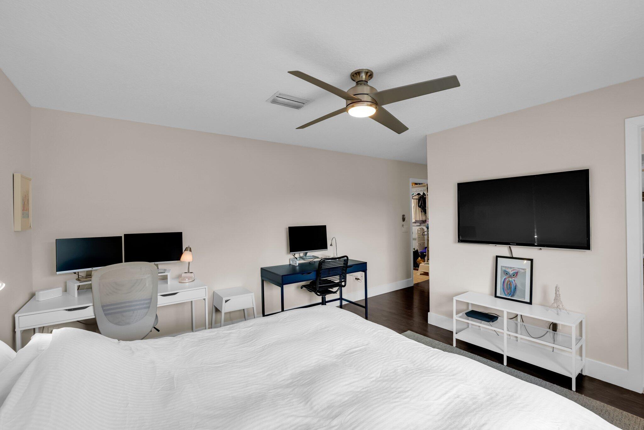 10323 Hidden Springs Court Boca Raton, FL 33498 - Photo 24 of 41 a bedroom with a bed and a flat screen tv