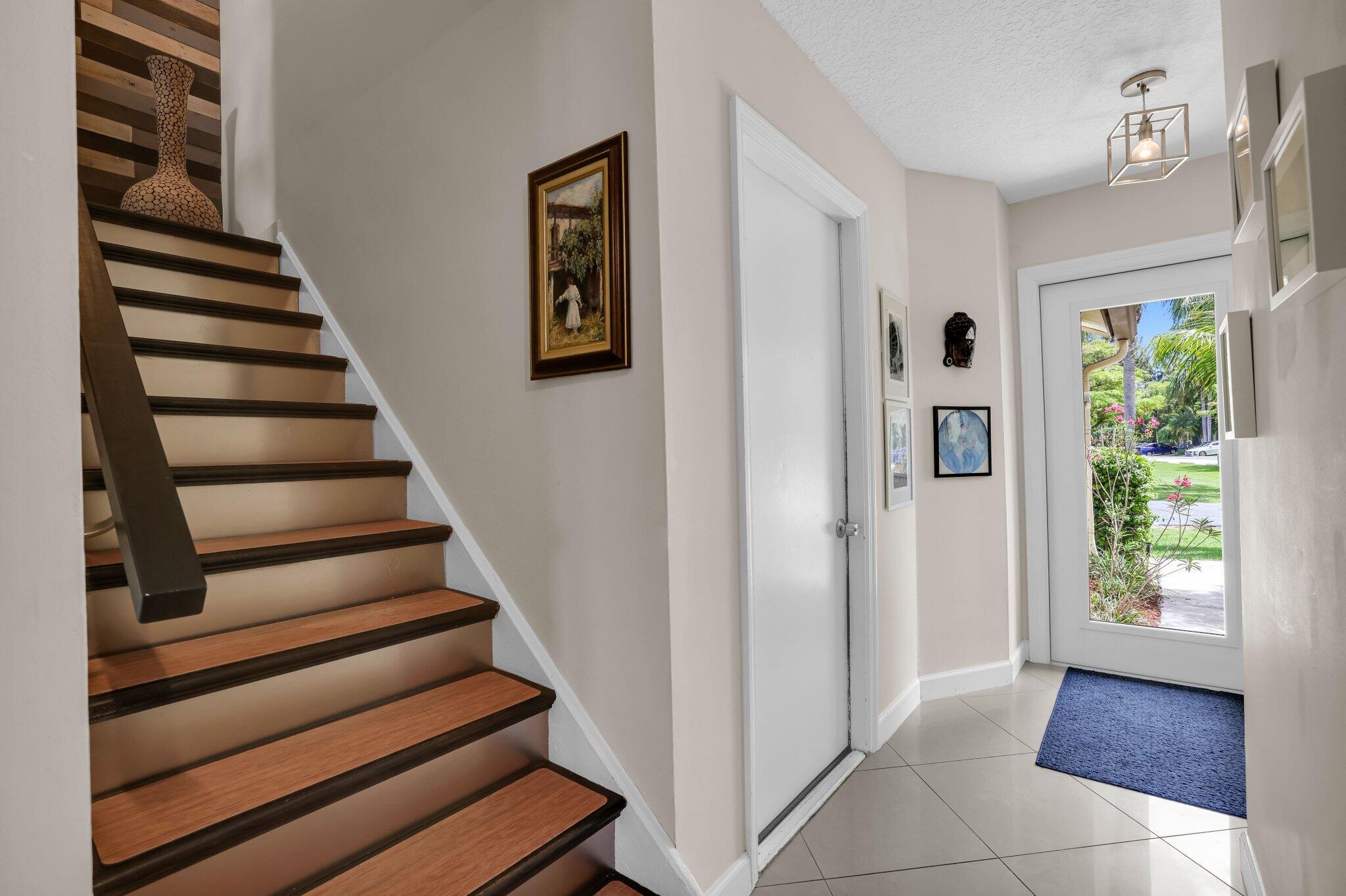10323 Hidden Springs Court Boca Raton, FL 33498 - Photo 4 of 41 a view of entryway with wooden floor and front door