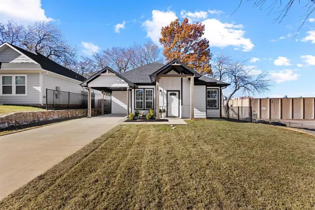 a view of a large house with wooden fence