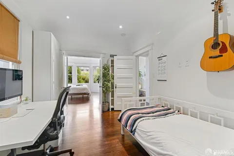 a bedroom with bed and a chair