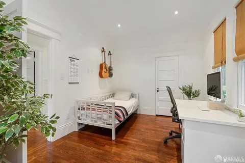 a bedroom with a bed and a potted plant