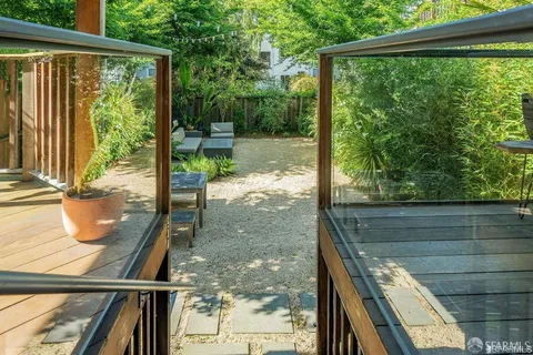 a view of a porch with wooden floor and outdoor seating