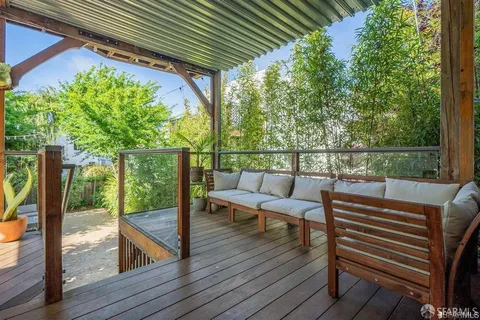 a view of a chairs and table on the wooden deck