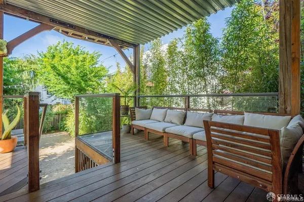 a view of a chairs and table on the wooden deck