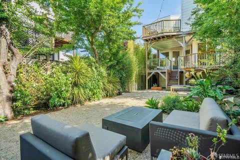 a view of a patio with table and chairs and potted plants