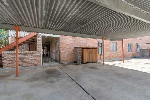 a view of an empty room with wooden roof and gate