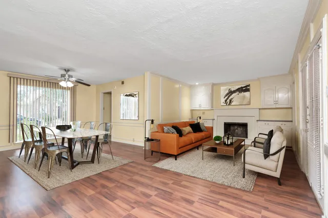 a living room with furniture a fireplace and a table
