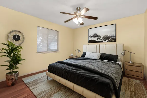 a bedroom with a bed and a potted plant