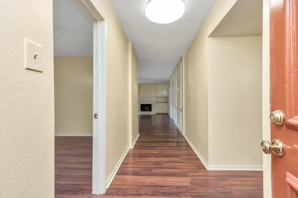 a view of a hallway with wooden floor