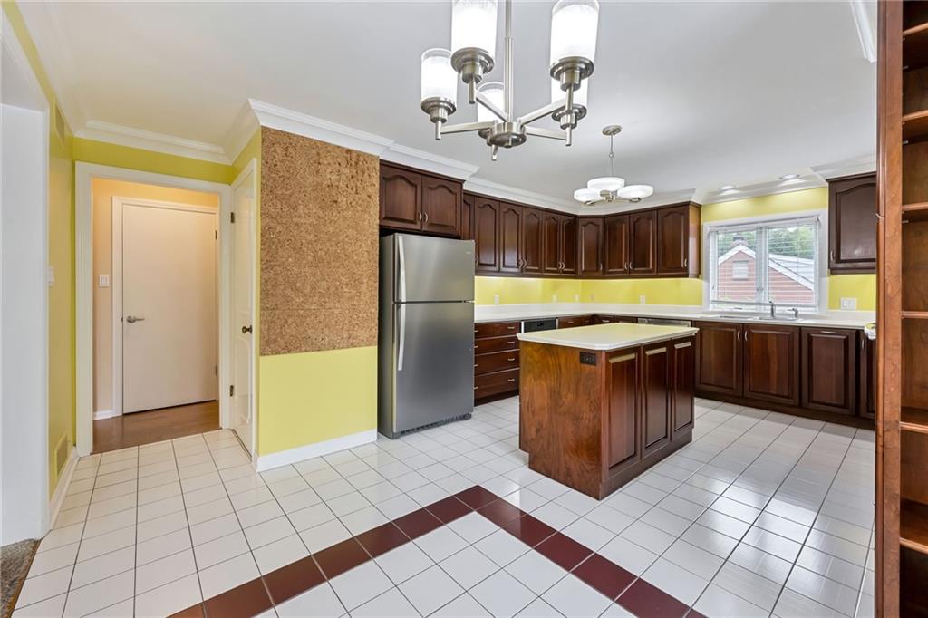 1001 Osage Road Pittsburgh, PA 15243 - Photo 19 of 42 a large kitchen with stainless steel appliances granite countertop a stove a refrigerator and a dining table