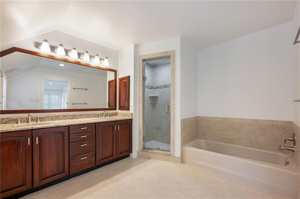 1001 Osage Road Pittsburgh, PA 15243 - Photo 27 of 42 a bathroom with a tub a double vanity sink and mirror