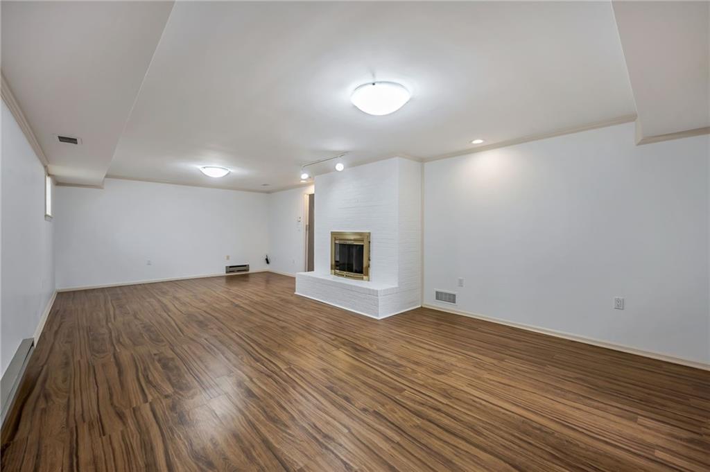1001 Osage Road Pittsburgh, PA 15243 - Photo 35 of 42 a view of empty room with wooden floor and fireplace