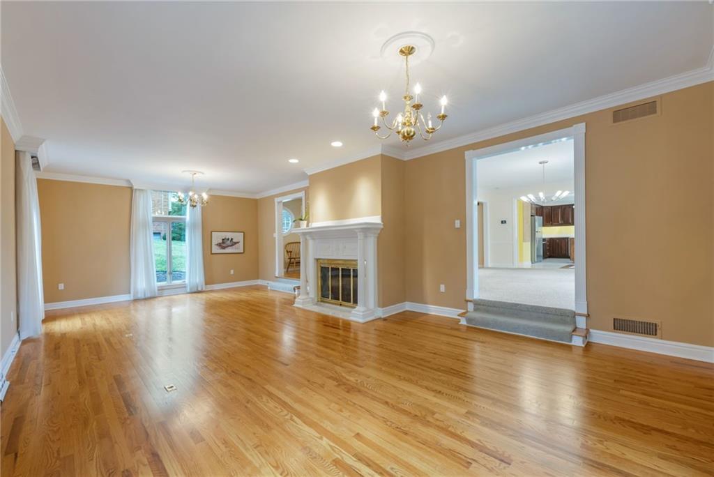 1001 Osage Road Pittsburgh, PA 15243 - Photo 7 of 42 a view of an empty room with wooden floor and a kitchen