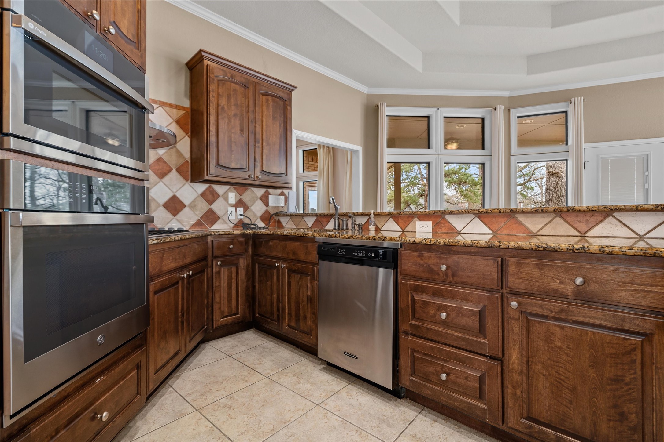 341 Lakeview Drive Grapeland, TX 75844 - Photo 13 of 31 a kitchen with granite countertop a sink and wooden cabinets