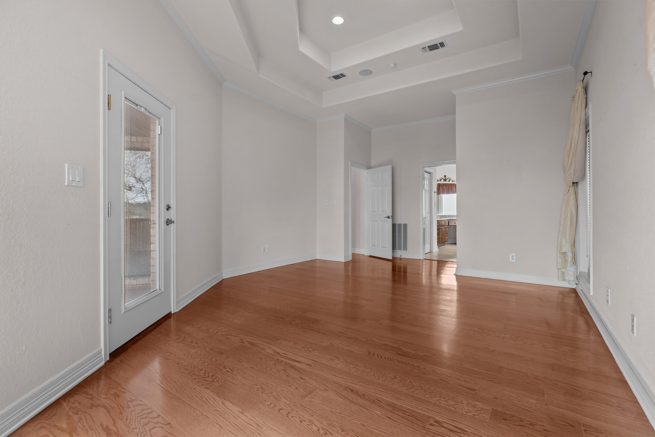 341 Lakeview Drive Grapeland, TX 75844 - Photo 16 of 31 a view of empty room with wooden floor and windows