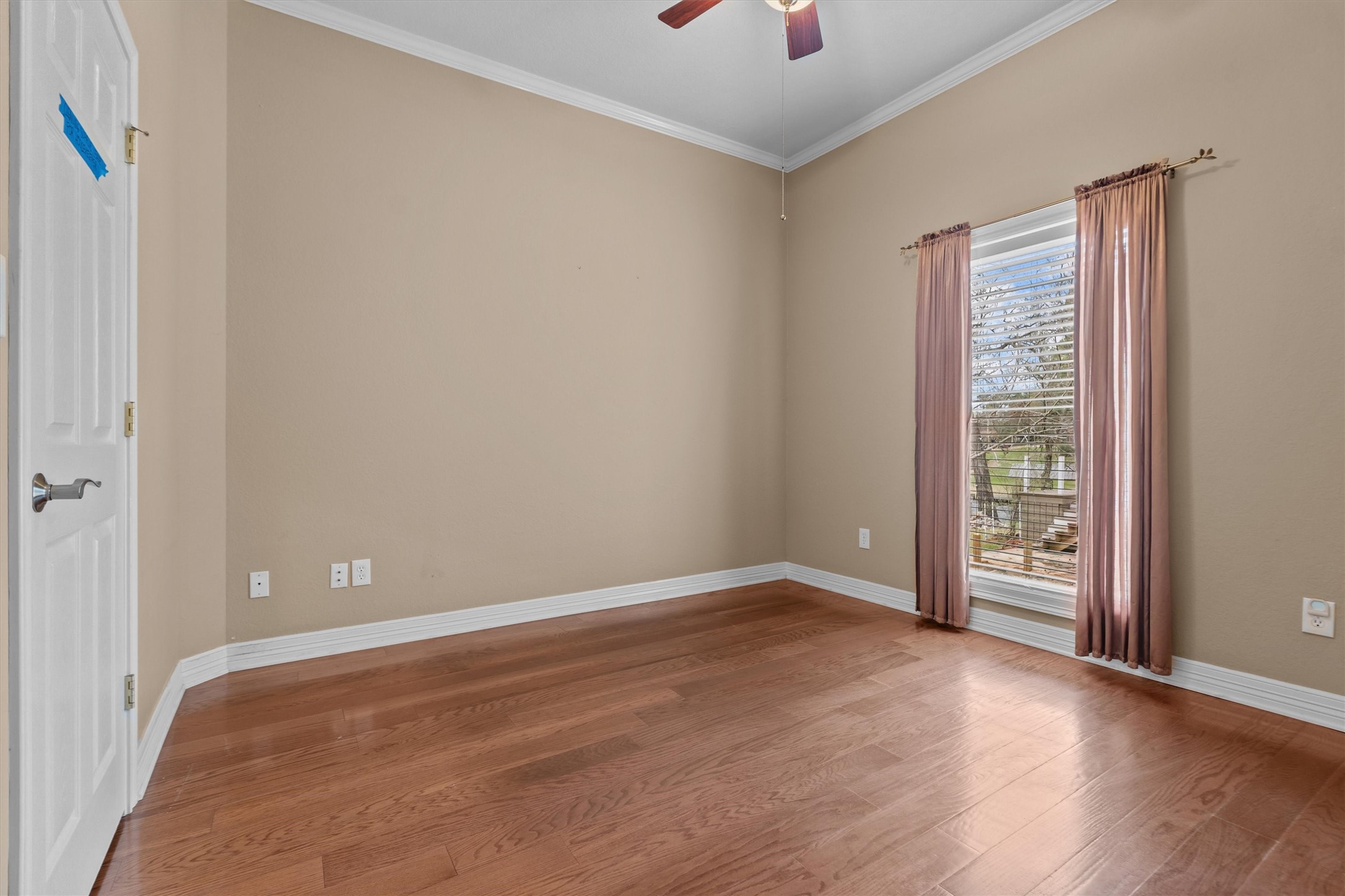 341 Lakeview Drive Grapeland, TX 75844 - Photo 19 of 31 a view of an empty room with wooden floor and a window