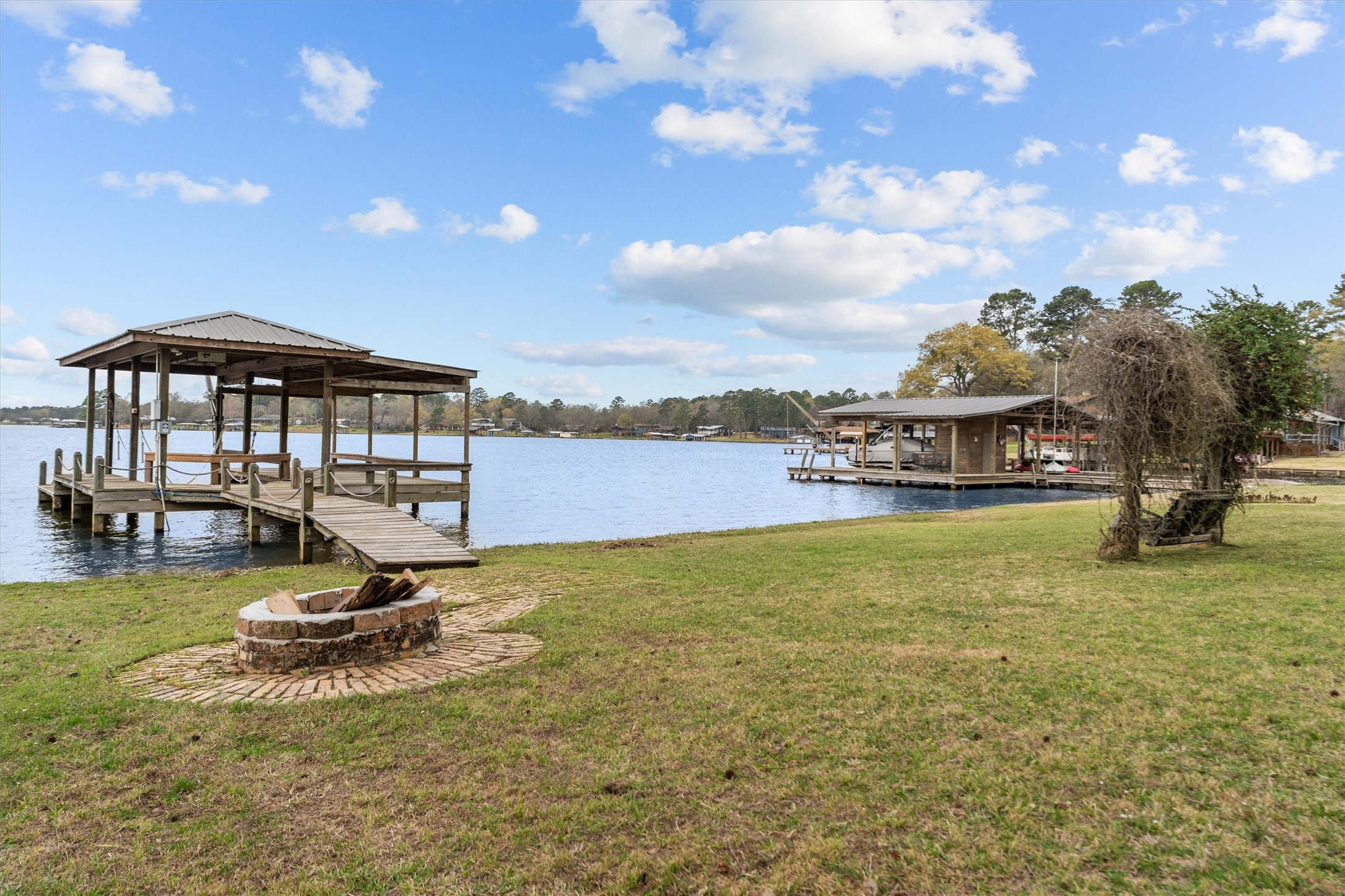 341 Lakeview Drive Grapeland, TX 75844 - Photo 27 of 31 a view of a lake with a house in the background
