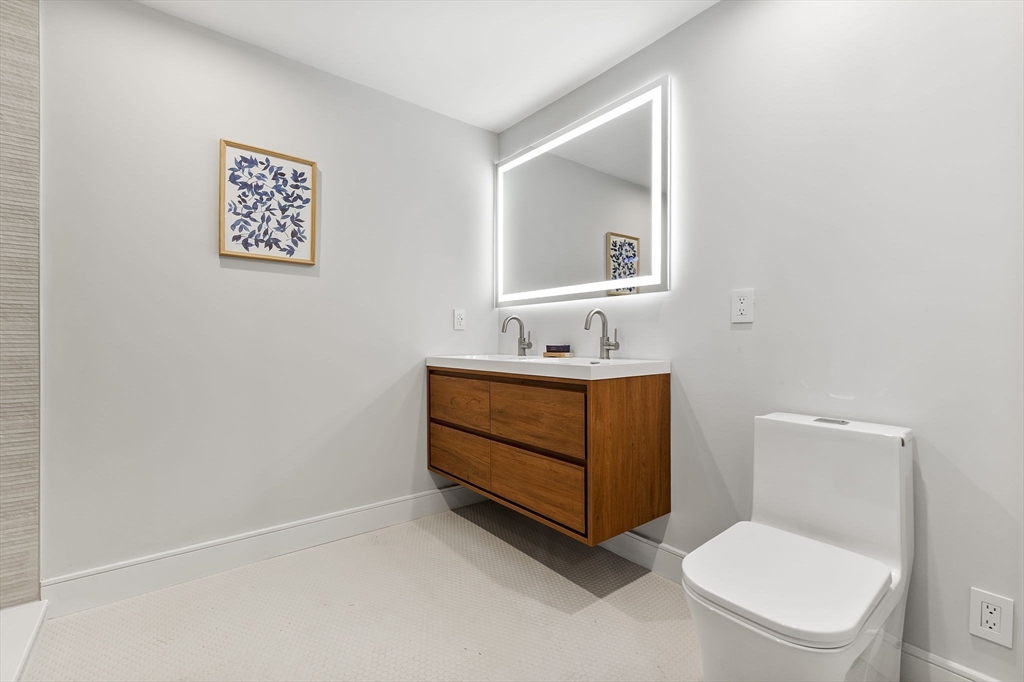 70 Birch Hill Road Belmont, MA 02478 - Photo 15 of 38 a bathroom with a toilet sink vanity and mirror
