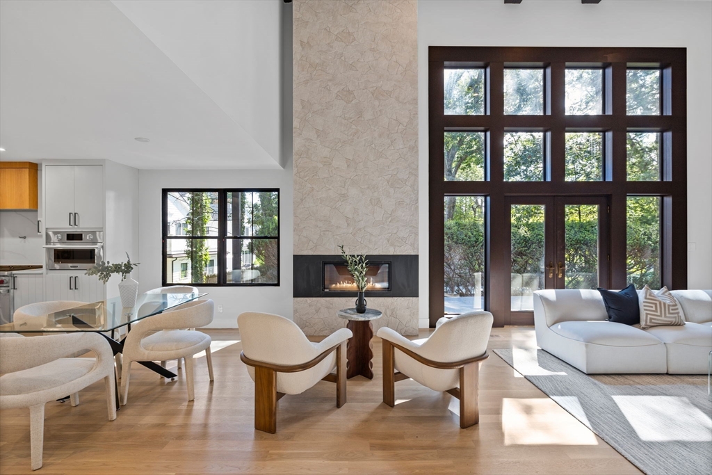 70 Birch Hill Road Belmont, MA 02478 - Photo 5 of 38 a living room with furniture a fireplace and large windows