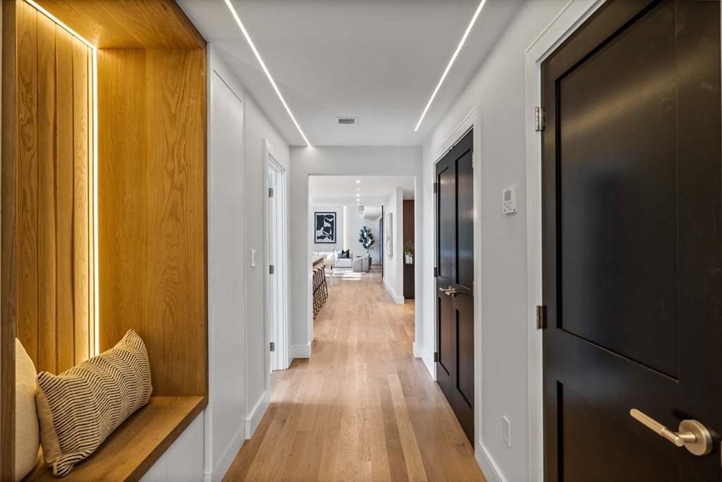 70 Birch Hill Road Belmont, MA 02478 - Photo 9 of 38 a view of a hallway with wooden floor and furniture