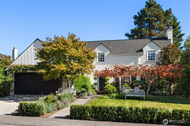 a view of a house with a big yard and potted plants