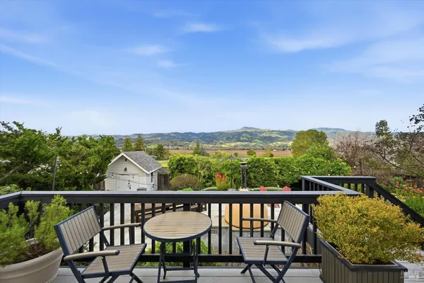 a view of a city from a balcony with furniture