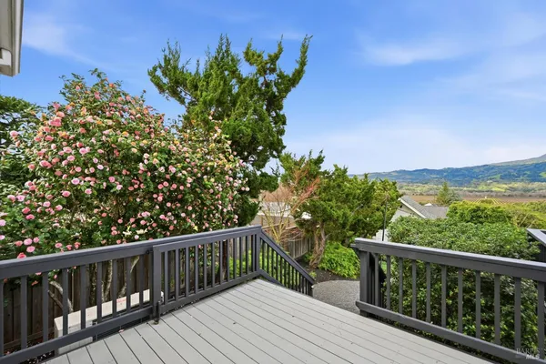 a balcony with wooden floor and fence