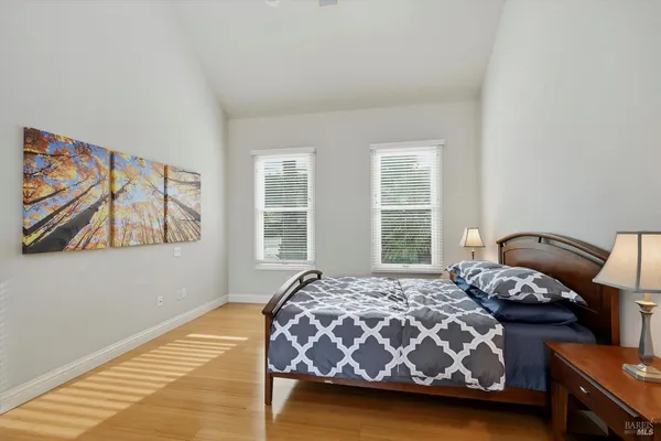 a bedroom with a bed and wooden floor