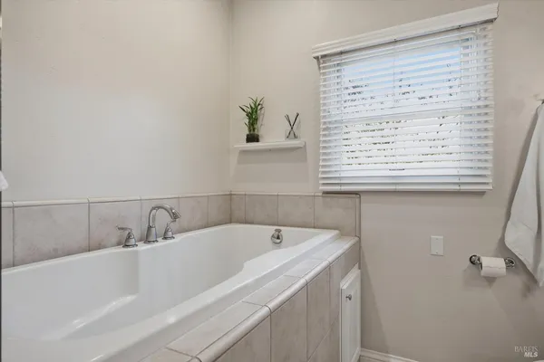 a bathroom with a bathtub and a window