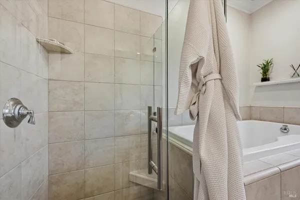 a bathroom with a sink a window and a shower